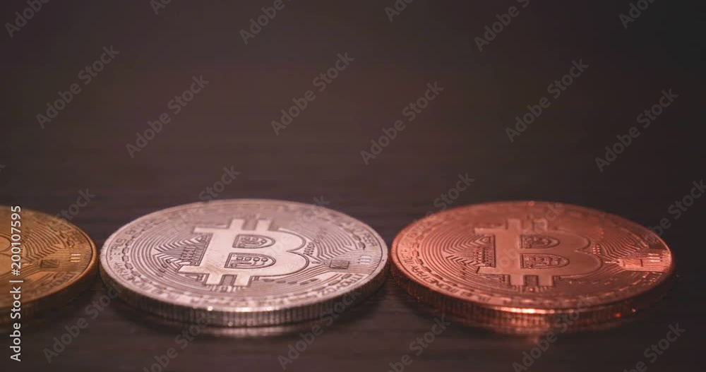 Gold, silver and bronze coin bitcoin, wooden background, Crypto currency course. Gold, silver and bronze coin bitcoin, wooden background, Crypto currency course.
