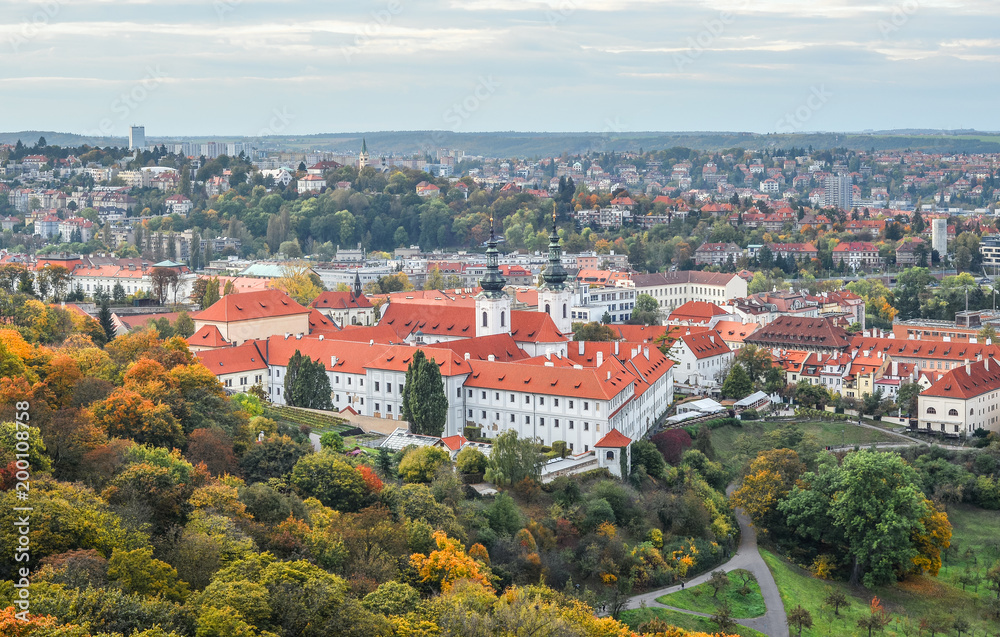 Prague, Czech Republic - October 10, 2017: Bright and beautiful autumn view on Prague Castle, Old town and city center with old red roofs, Prague, Czech Republic