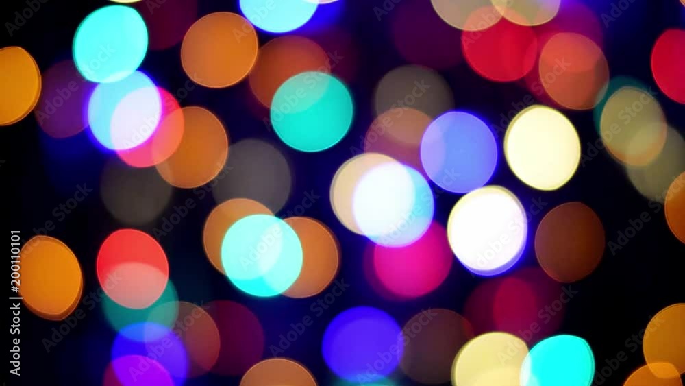 Bokeh background, multi colored blurred flickering Christmas fairy lights at night. Bokeh background, multi colored blurred flickering Christmas fairy lights at night.