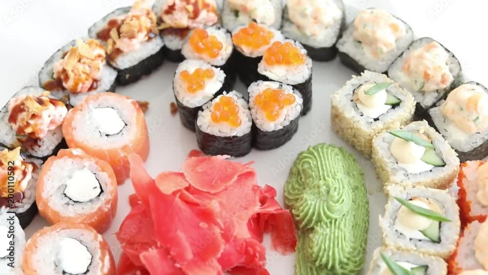 Sushi roll set on white plate background. Sushi japanese food in restaurant. Japan restaurant menu top view Sushi roll set on white plate background. Sushi japanese food in restaurant. Japan restaurant menu top view