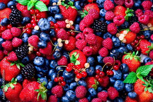Macro colorful berries background. Top view. Summer food frame  border design. Assorted mix of strawberry  blueberry  raspberry  blackberry  currant  mint. Vitamin  vegan  vegetarian concept.