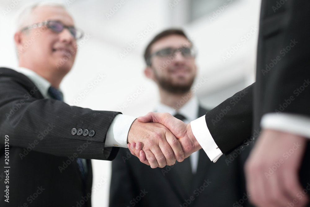 closeup handshake proven business partners