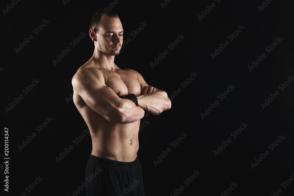 Strong athletic man showes naked muscular body Strong athletic man showes naked muscular body
