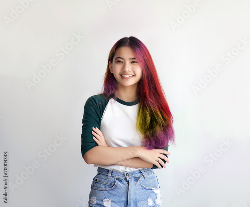 pretty asian female smiling joyfully with colorful hair in dressed casually like hipster lifestyle