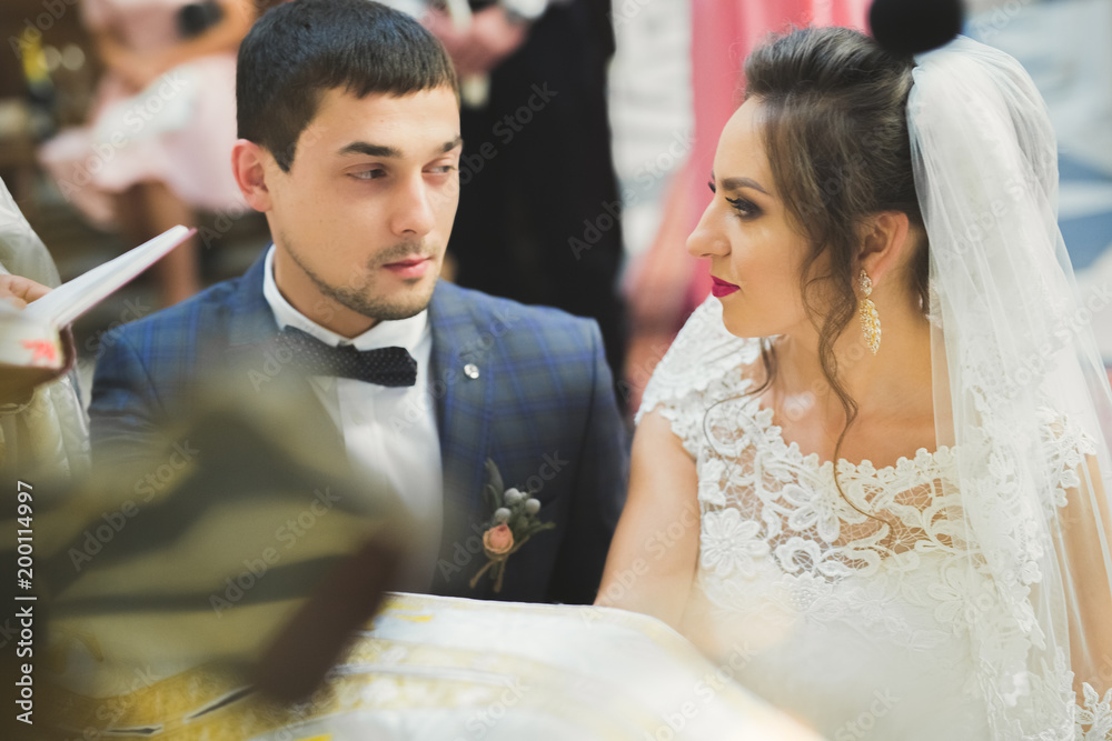 Married couple posing in a church after ceremony Married couple posing in a church after ceremony