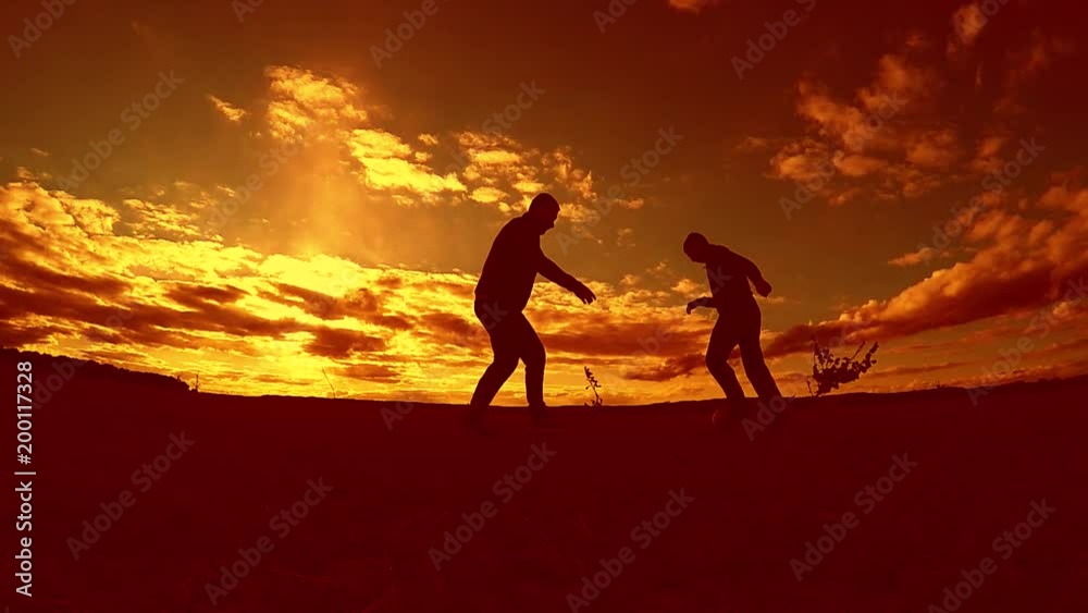 two man soccer player playing with ball during sunset silhouette slow motion video. men playing European outdoors soccer on nature sunset sunlight silhouette the lifestyle two man soccer player playing with ball during sunset silhouette slow motion video. men playing European outdoors soccer on nature sunset sunlight silhouette the lifestyle