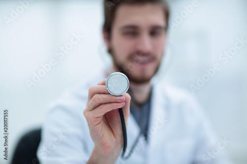 stethoscope in the hands of the doctor
