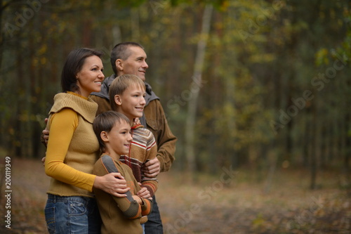 Family in autumn forest looking away © aletia2011