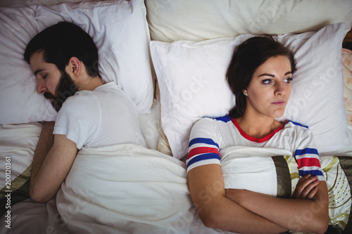 Upset woman lying on bed photo