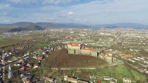 Beautiful panoramic aerial view to Palanok Castle at day and the city of Mukachevo photo