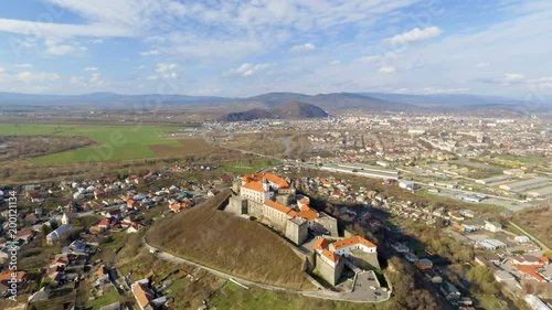 Beautiful panoramic aerial view to Palanok Castle at day and the city of Mukachevo photo