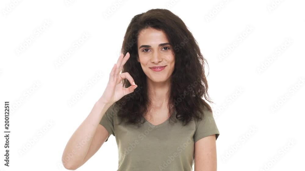 Portrait of satisfied hispanic woman wearing basic clothing gesturing ok symbol expessing approval, isolated on white background. Concept of emotions Portrait of satisfied hispanic woman wearing basic clothing gesturing ok symbol expessing approval, isolated on white background. Concept of emotions
