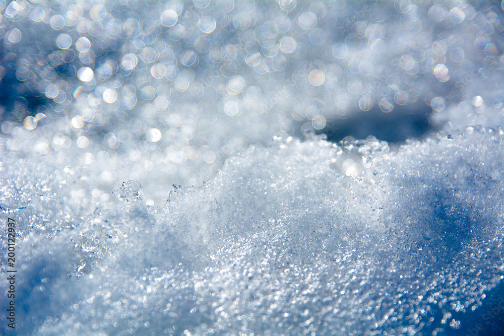 Closeup of a beautiful Christmas blue background of melted snow and bokeh Closeup of a beautiful Christmas blue background of melted snow and bokeh