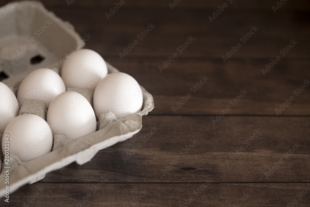 Farm Fresh White Chicken Eggs on a Dark Wood Table Farm Fresh White Chicken Eggs on a Dark Wood Table