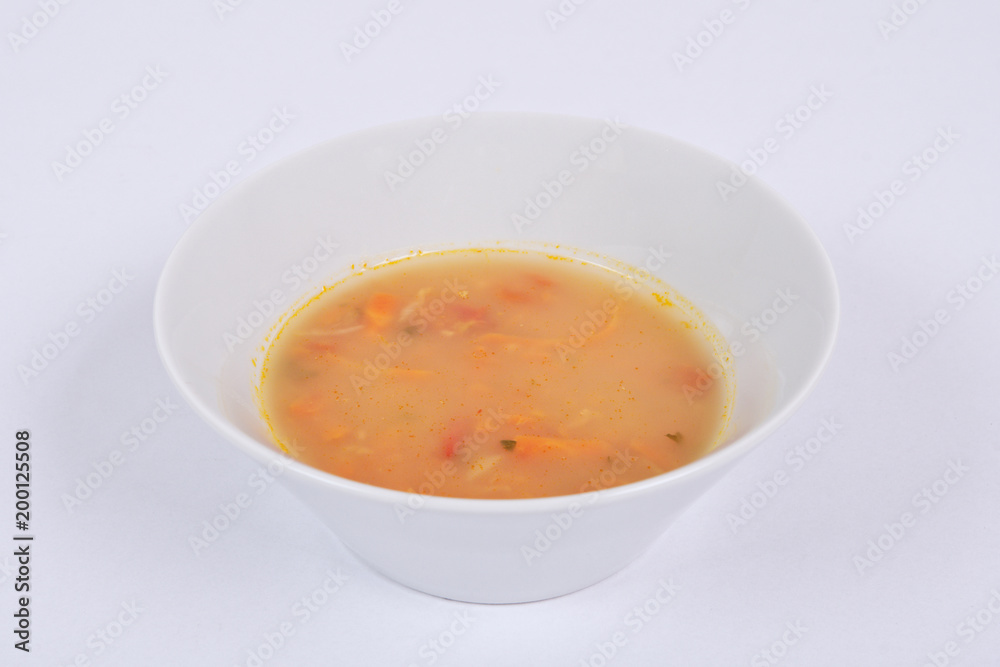 Bean soup with millets and vegetables on a white Bean soup with millets and vegetables on a white
