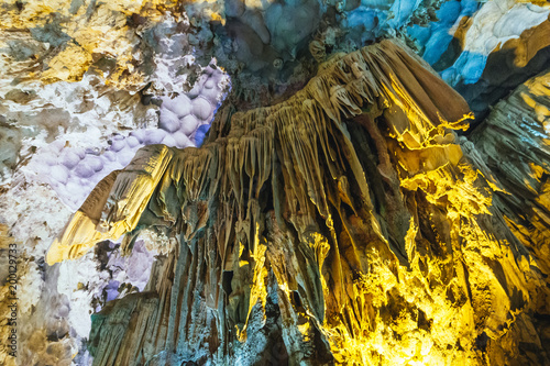 Inside Dong Thien Cung Cave that decorated with artificial yellow and blue lights at Ha Long Bay. Quang Ninh, Vietnam. photo