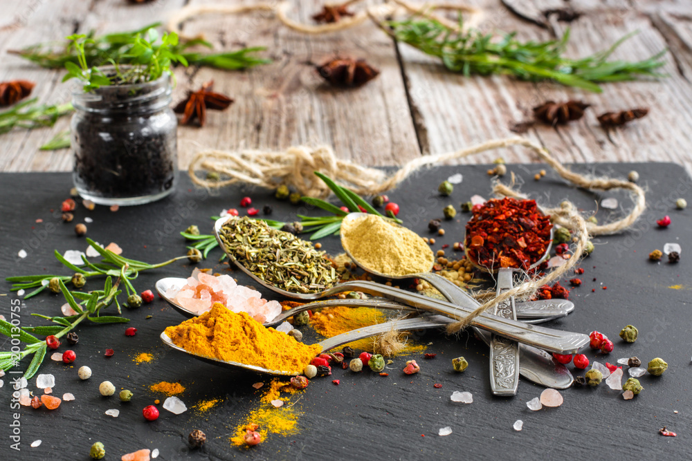 Spices and herbs. Variety of spices and herbs on a wooden surface Spices and herbs. Variety of spices and herbs on a wooden surface