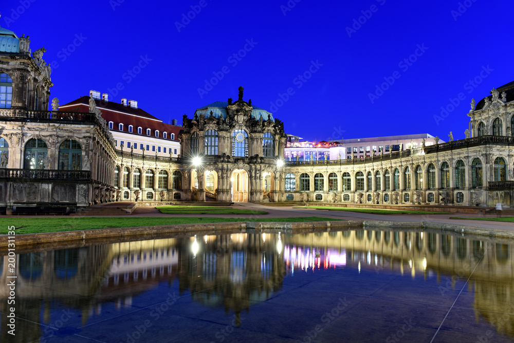 Panorama of Dresden Zwinger Palace in Rococo style at night with reflection in water bassin, Dresden, Saxony, Eastern Germany