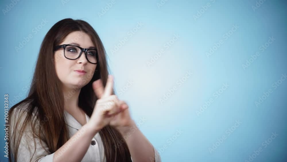 Young woman say no, trying to avoid offer, rejecting gesture, disagree sign. Serious determined face expression, on blue 4K ProRes HQ codec Young woman say no, trying to avoid offer, rejecting gesture, disagree sign. Serious determined face expression, on blue 4K ProRes HQ codec