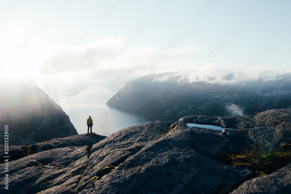 Fototapeta premium Misty morning on Preikestolen (pulpit-rock) - famous tourist attraction in the municipality of Forsand in Rogaland county, Norway