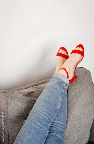 womens legs couch clothing jeans red shoes stilettos