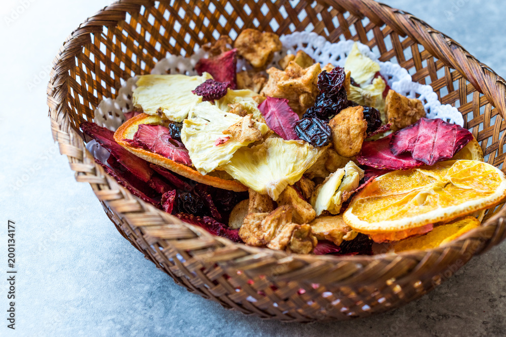 Mixed Dried Fruits Orange, Strawberry, Pineapple, Cherry and Apple Slices with Cinnamon Powder in Wooden Basket. Mixed Dried Fruits Orange, Strawberry, Pineapple, Cherry and Apple Slices with Cinnamon Powder in Wooden Basket.