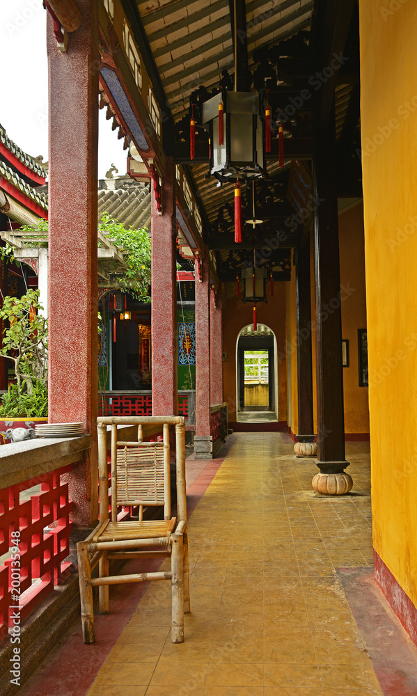 Fototapeta premium A bamboo chair in the historic Hainan Assembly Hall in the UNESCO listed central Vietnamese town of Hoi An 