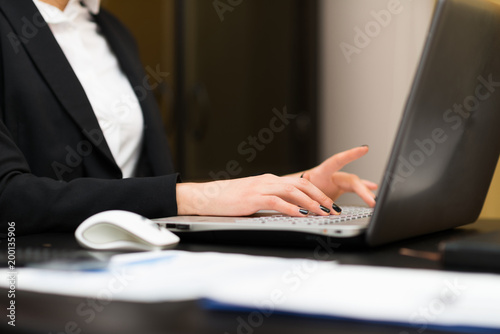 Woman using a laptop in her office