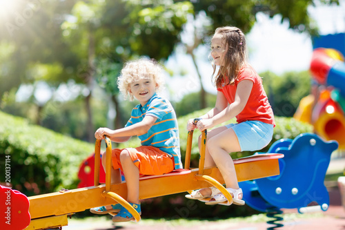 Kids on playground. Children play in summer park.