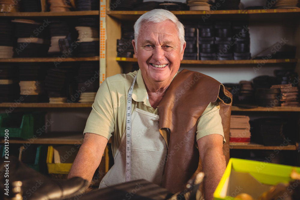 Portrait of shoemaker sitting in workshop Portrait of shoemaker sitting in workshop