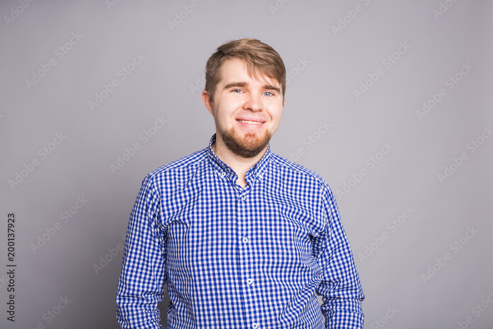 Fototapeta premium Portrait of a handsome young man against blue background