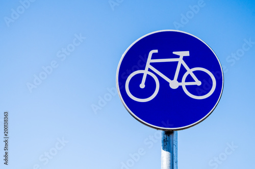 Bicycle route sign against blue sky