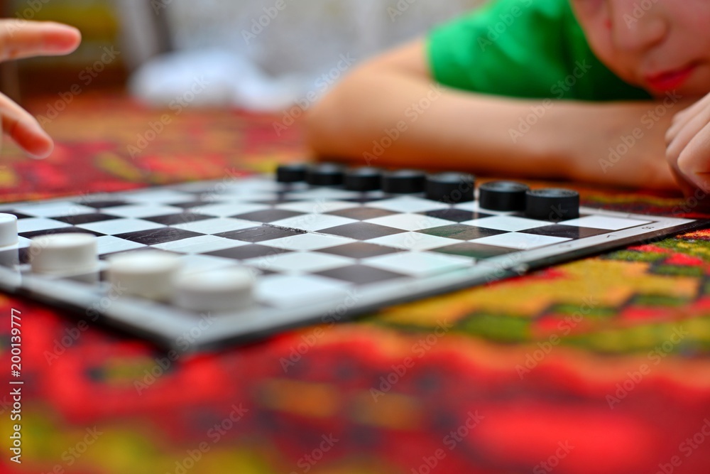 People are playing checkers close-up, the concept of a board game. People are playing checkers close-up, the concept of a board game.