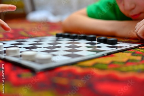 People are playing checkers close-up, the concept of a board game.