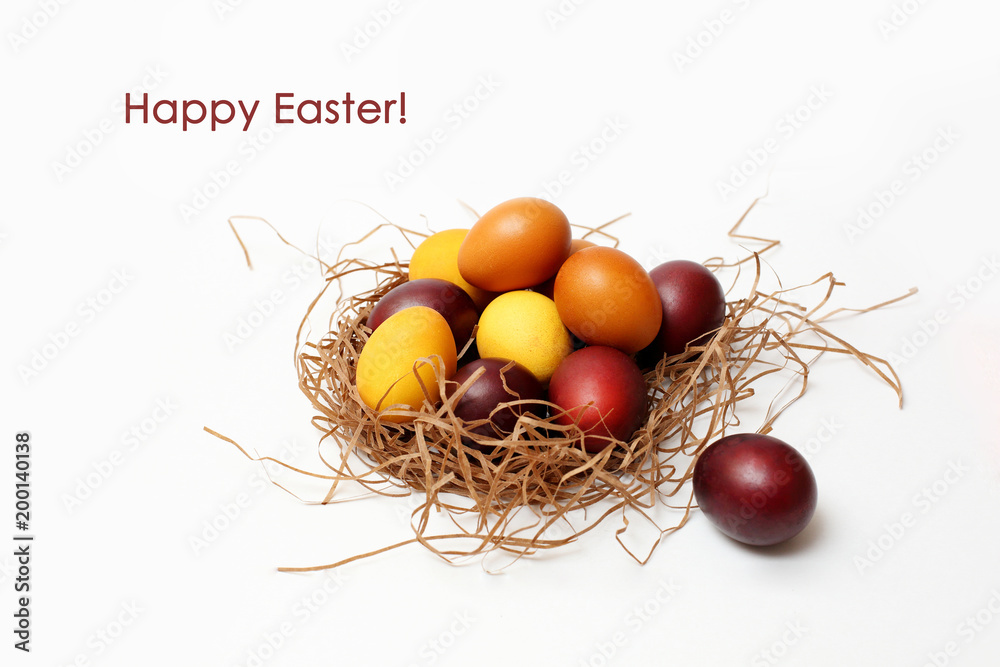red and yellow Easter eggs in basket on white background