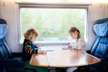 Kids travel by train. Railway trip with child.