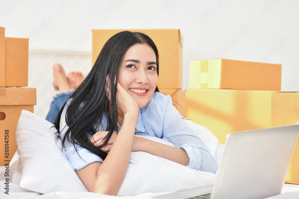 Sme business concept. Young people are packing their packages.Delivery business Small and Medium Enterprise (SMEs). Young woman is working in the house.Young Owner Start up for Business Online. Sme business concept. Young people are packing their packages.Delivery business Small and Medium Enterprise (SMEs). Young woman is working in the house.Young Owner Start up for Business Online.
