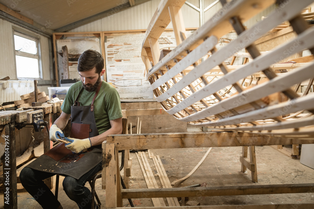 Carpenter shaping wood in workshop Carpenter shaping wood in workshop
