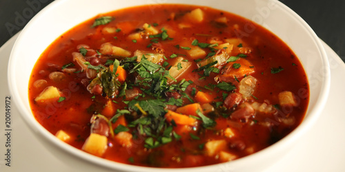 Tomato soup with red beans, potato and carrot. Vegan diet. European cuisine. Vegetarian dish. Main course. Organic meal. Wide photo.