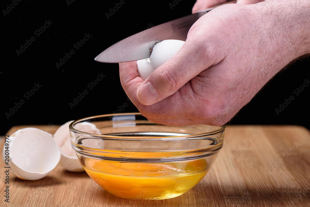 Destruction of a chicken white egg with a knife Destruction of a chicken white egg with a knife