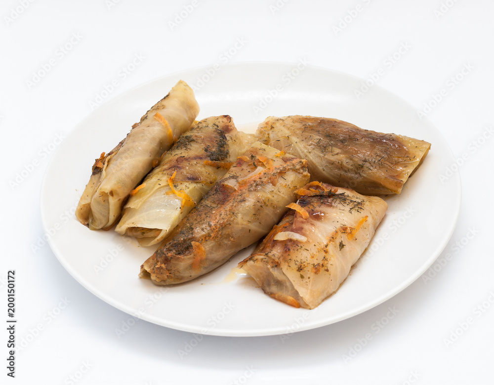 Tasty stuffed cabbage leaf laying on plate on isolated white background