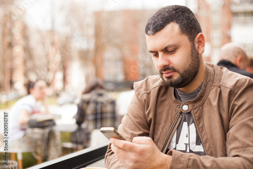 Man using smartphone outdoors