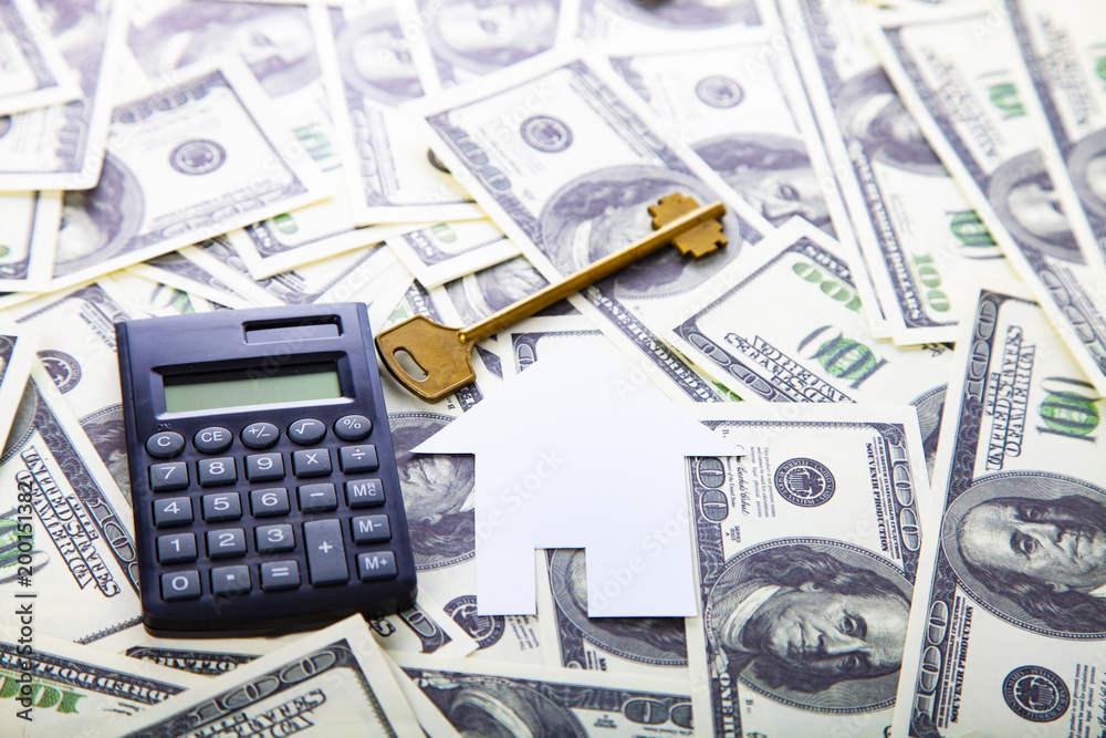 Cardboard house,calculator and key Cardboard house,calculator and key