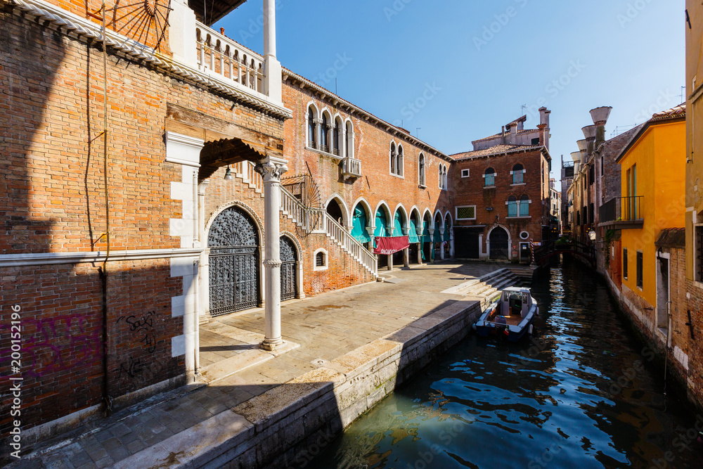 Typical view of boats on the canal near the largest fish market of Venice