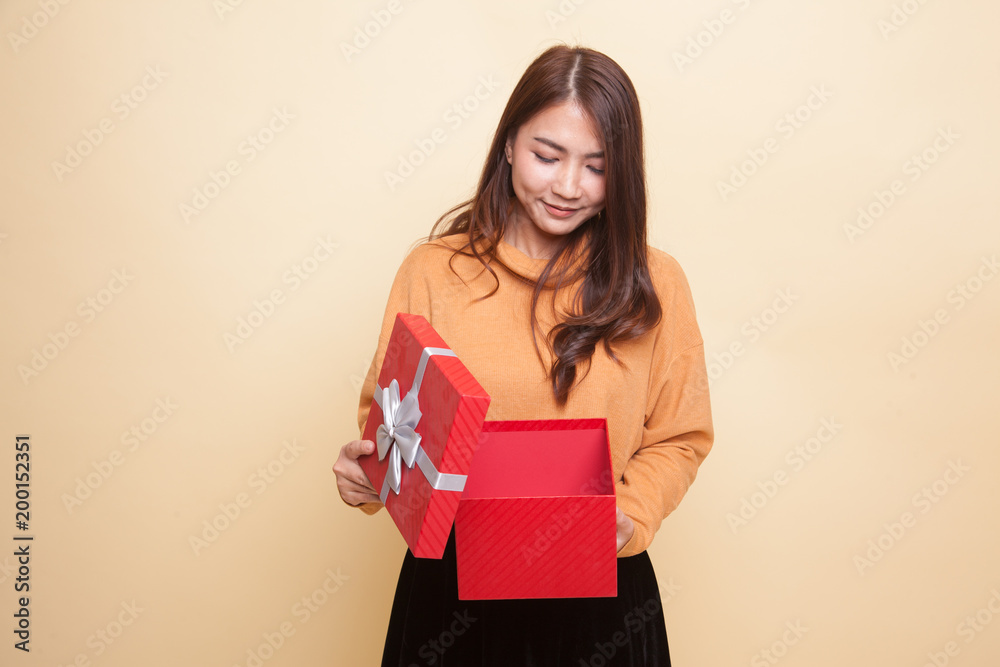 Young Asian woman open a gift box. Young Asian woman open a gift box.