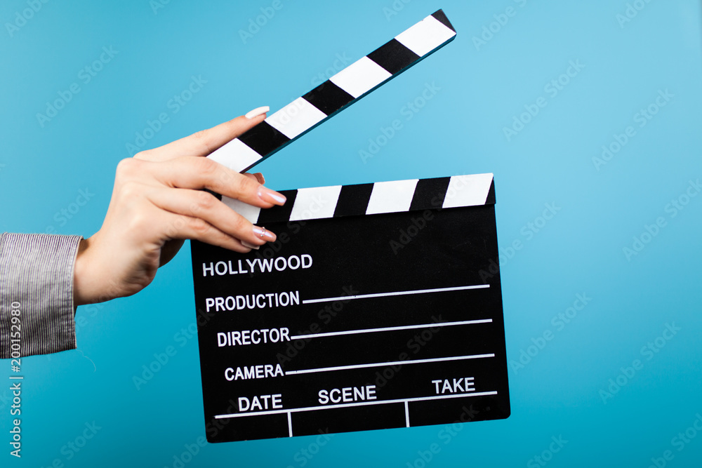 Fototapeta premium Female hands holding a clapperboard