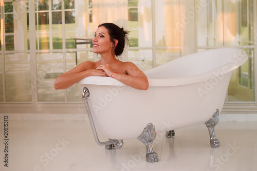 Woman being relaxed in a bathtub
