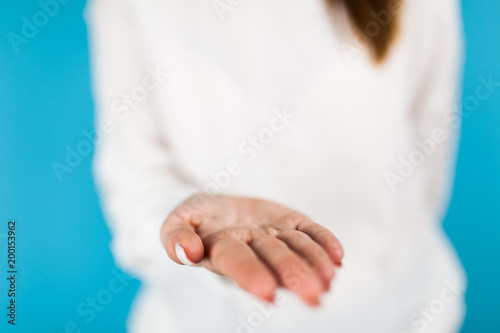 Female hands on blue background