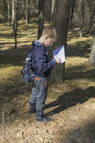 adventure, travel, hiking, trekking and people's concept - walks with backpacks in the forest