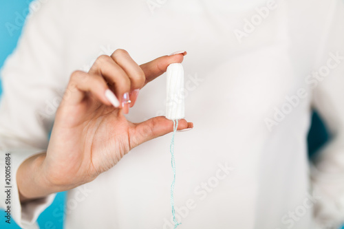 Woman holding a tampon